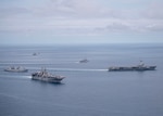 ANDAMAN SEA (June 7, 2019) Amphibious assault ship USS Boxer (LHD 4) conducts a breakaway in the Andaman Sea with French aircraft carrier FS Charles de Gaulle (R 91), anti-submarine destroyer FS Latouche Treville (D 646), anti-submarine frigate FS Provence (D 652) and underway replenishment tanker FS Marne (A 630) during a photo exercise. The Boxer Amphibious Ready Group (ARG) and 11th Marine Expeditionary Unit (MEU) are deployed to the U.S. 7th Fleet area of operations to support regional stability, reassure partners and allies, and respond to any crisis ranging from humanitarian assistance to contingency operations.