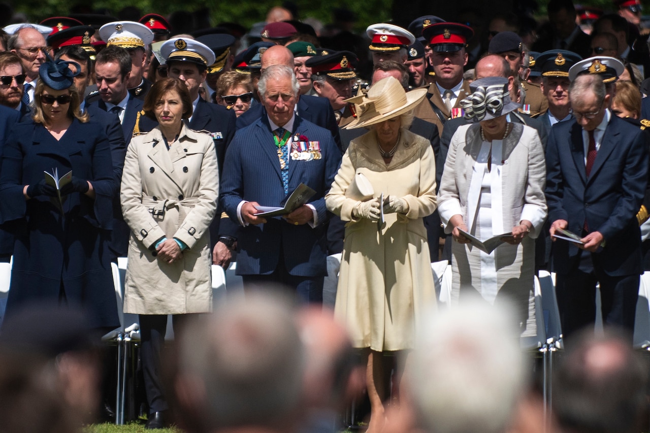 British French, U.S. leaders bow heads.