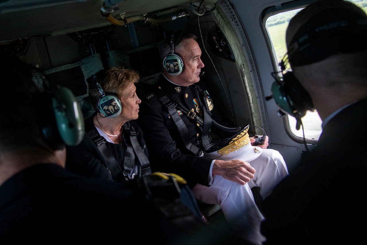 Marine Corps general and wife look out window of helicopter