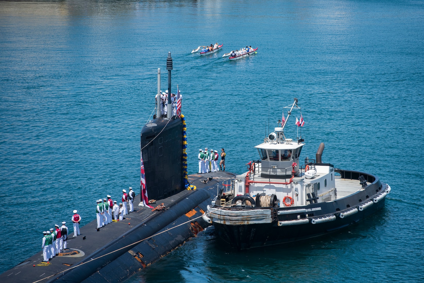 190606-N-SF508-0184 JOINT BASE PEARL HARBOR-HICKAM, Hawaii (June 6, 2019) Members of the Outrigger Canoe Club escort the Virginia-class fast attack submarine USS Hawaii (SSN 776) as it arrives at Joint Base Pearl Harbor-Hickam, after completing its latest deployment, June 6. (U.S. Navy Photo by Mass Communication Specialist 2nd Class Charles Oki/Released)