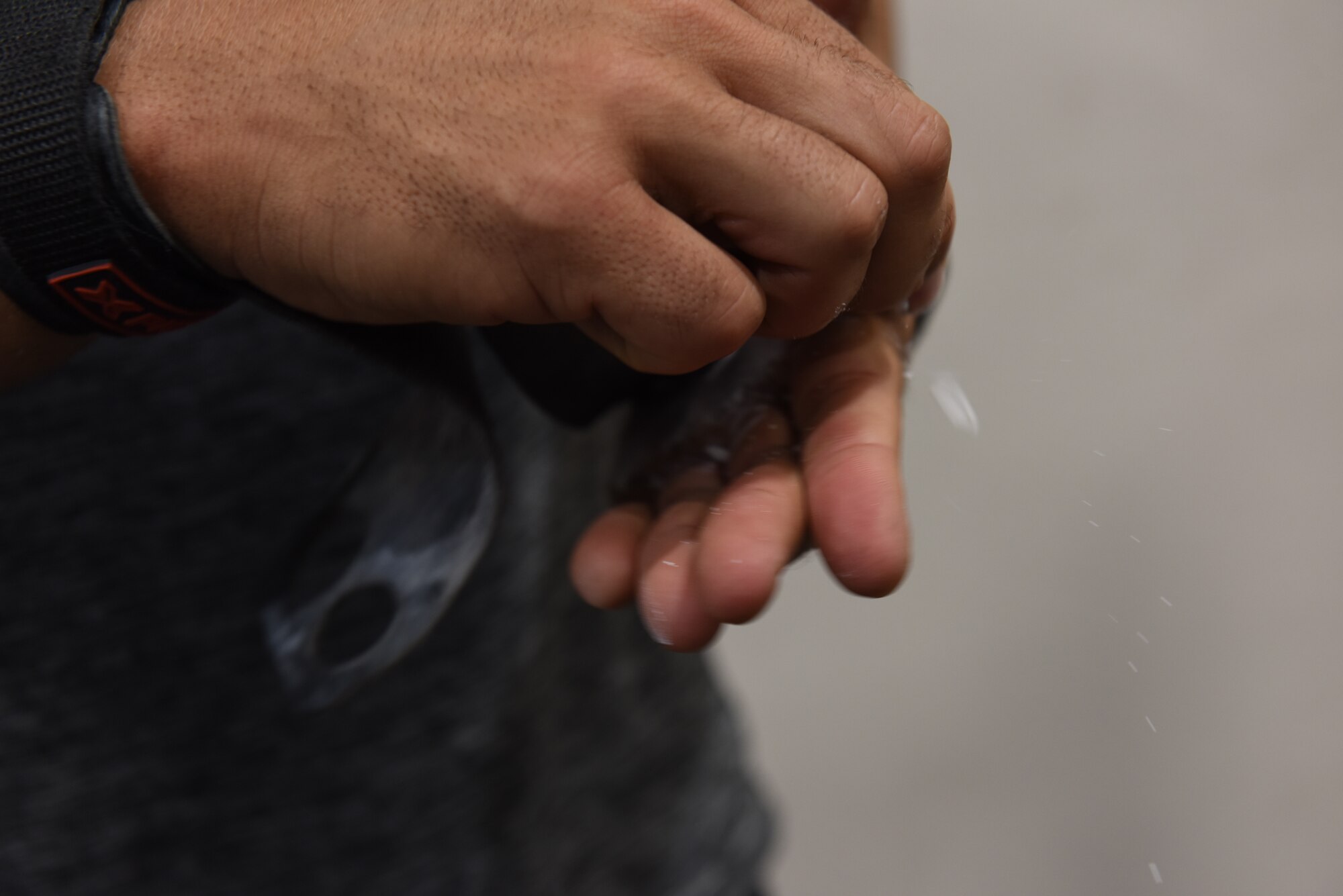 Spanish Patriot Unit member Sargento Alfonso Mendonza, Spanish Patriot Unit, applies chalk to his hands at the Larger than Life Fitness Center on June 5, 2019, at Incirlik Air Base Turkey. Chalk prevents lifters from losing grip while lifting, as well as protects against skin tears. (U.S. Air Force photo by Staff Sgt. Matthew J. Wisher)