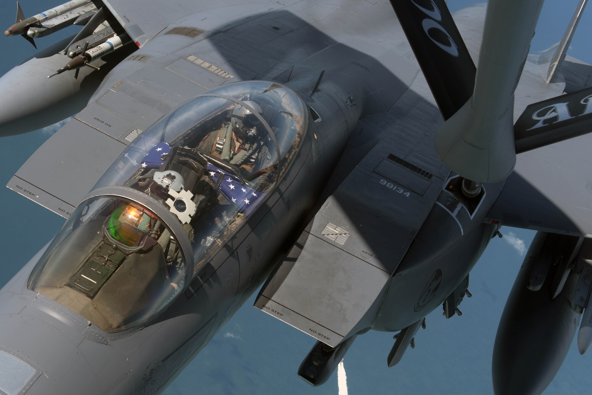 A U.S. Air Force F-15E Strike Eagle, assigned to the 492nd Fighter Squadron  at RAF Lakenheath, England, receives fuel from a U.S. Air Force KC-135 Stratotanker off the Southern coast of England, June 6, 2019. The Strike Eagle received fuel before taking part in a flight to commemorate the 75th anniversary of D-Day over France. Highlighting the strength of the U.S. commitment to European security, U.S. Air Force aircraft and other allied forces performed commemorative airborne operations across the European theater in support of the 75th anniversary of D-Day. (U.S. Air Force photo by Senior Airman Benjamin Cooper)