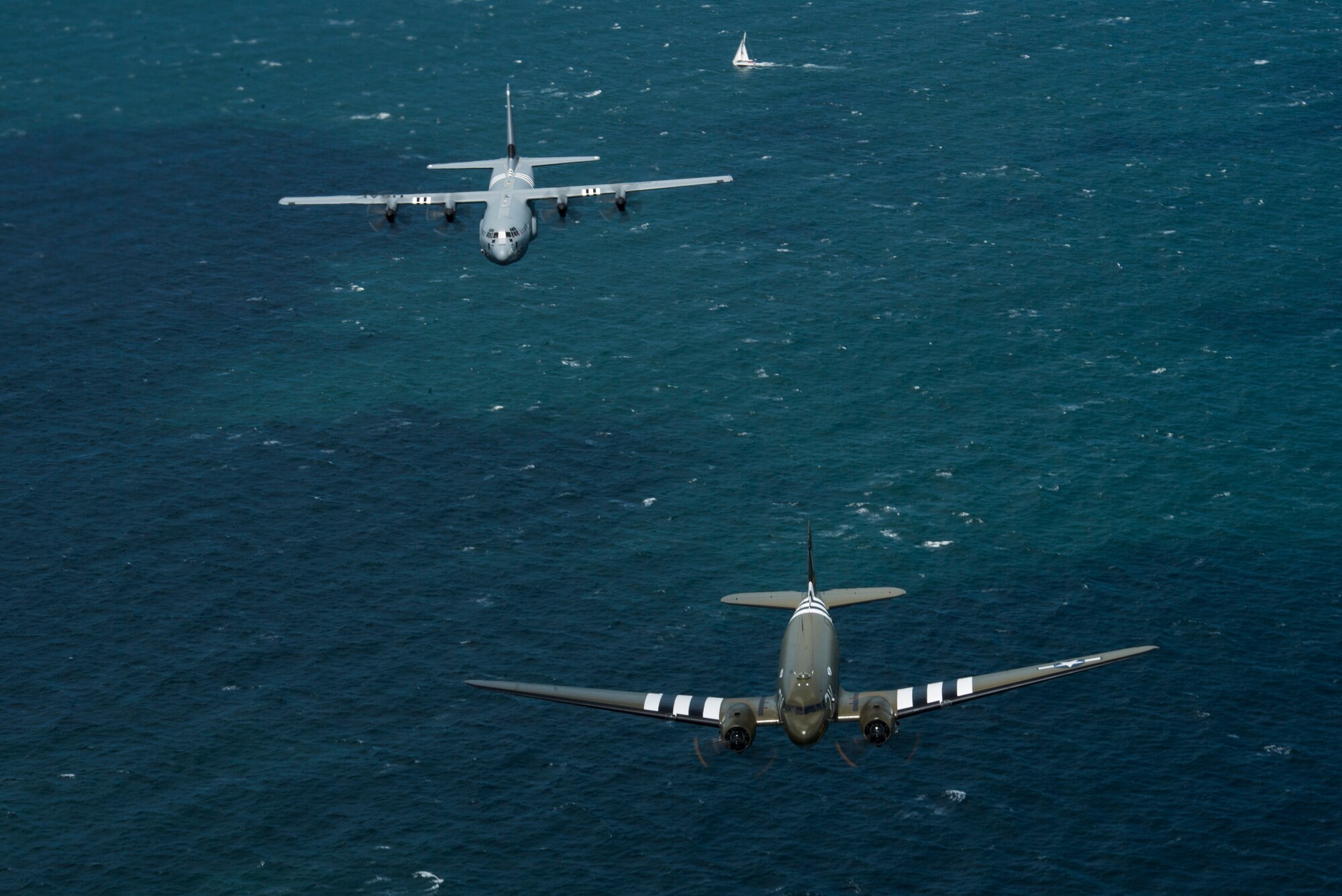 A Douglas C-47 Dakota, nicknamed “That’s All Brother”, flies with a U.S. Air Force C-130J Super Hercules, assigned to the 37th Airlift Squadron, Ramstein Air Base, Germany, over the English Channel, June 8, 2019. The 37th Troop Carrier Squadron, the legacy squadron to the 37th AS, wore the “W7” or “Whiskey 7” markings during Operation Neptune, June 6, 1944. “That’s All Brother” flew operations during the invasion of Normandy. (U.S. Air Force photo by Senior Airman Devin M. Rumbaugh)