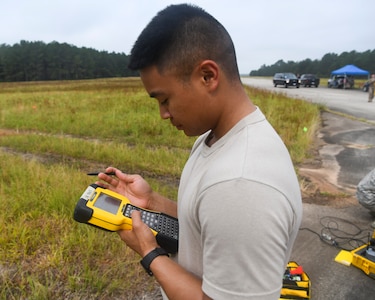 Airman 1st Class Jake Roxas, an engineering assistant assigned to the 628th Civil Engineer Squadron, S.C., calibrates a Trimble R8 global positioning receiver using a handheld unit, June 5, 2019 at North Auxiliary Airfield, S.C., during an aircraft crash assessment exercise. Airmen used specialized receivers that help them track the position of potential debris. Engineering assistants specialize in planning and managing construction projects for military installations and ensuring that facilities and structures are able to operate at full capacity.