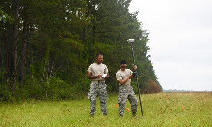 Airmen 1st Class Miguel Alano (left) and Jake Roxas (right), engineering assistants assigned to the 628th Civil Engineer Squadron, walk the field to determine the position of simulated aircraft wreckage, June 5, 2019 at North Auxiliary Airfield, S.C., during a crash assessment exercise. The exercise provided Airmen with the opportunity to practice on-seen protocols and to coordinate with other Airmen from Shaw Air Force Base, S.C., to completely map out debris in a simulated aircraft mishap. Air Force engineering assistants have the role of plotting out the positions of all debris pieces using global positioning devices during crash analysis operations. Engineering assistants specialize in planning and managing construction projects for bases and ensuring that facilities and structures are able to operate at full capacity.