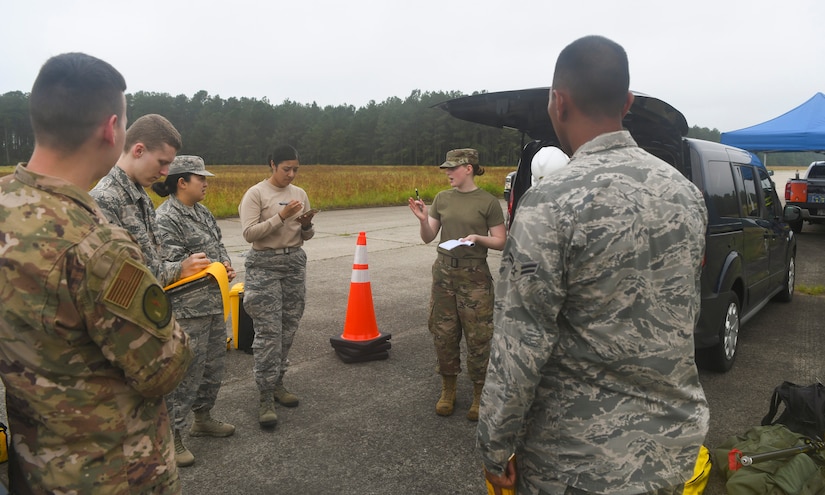 Engineering assistants from the 628th Civil Engineer Squadron out of Joint Base Charleston, S.C. and the 20th CES out of Shaw Air Force Base, S.C., discuss their mission plan during an aircraft crash analysis exercise June 5, 2019, at North Auxiliary Airfield, S.C. The exercise allowed Airmen to enhance their readiness and job knowledge by simulating an on-scene aircraft crash with real world requirements and standards. Air Force engineering assistants have the role of plotting out the positions of all debris pieces using global positioning devices during crash analysis operations. Engineering assistants specialize in planning and managing construction projects for military installations and ensuring that facilities and structures are able to operate at full capacity.