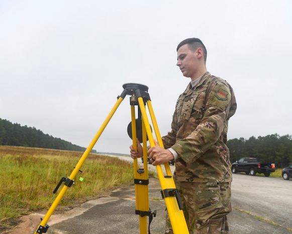 U.S. Air Force Staff Sgt. Kennith Hopkins, an engineering assistant from the 20th Civil Engineer Squadron at Shaw Air Force Base, S.C., sets up a tripod during an aircraft crash analysis exercise June 5, 2019, at North Auxiliary Airfield, S.C. Joint Base Charleston engineering assistants were joined by their counterparts from Shaw Air Force Base to help younger Airmen learn what it’s like to coordinate with other bases during a real world crisis scenario. Air Force engineering assistants have the role of plotting out the positions of all debris pieces using global positioning devices during crash analysis operations. Engineering assistants specialize in planning and managing construction projects for military installations and ensuring that facilities and structures are able to operate at full capacity. (U.S. Air Force photo by Senior Airman Cody R. Miller)