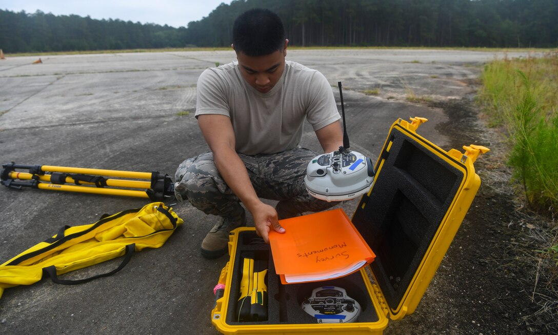 Airman 1st Class Jake Roxas, an engineering assistant assigned to the 628th Civil Engineer Squadron, sets up a global positioning device during a crash assessment exercise June 5, 2019 at North Auxiliary Airfield, S.C. The exercise provided participants the opportunity to practice on-seen protocols and to coordinate with other Airmen from Shaw Air Force Base, S.C. to completely map out debris in a simulated aircraft mishap. Air Force engineering assistants have the role of plotting out the positions of all debris pieces using global positioning devices during crash analysis operations. Engineering assistants specialize in planning and managing construction projects for military installations and ensuring that facilities and structures are able to operate at full capacity. (U.S. Air Force photo by Senior Airman Cody R. Miller)