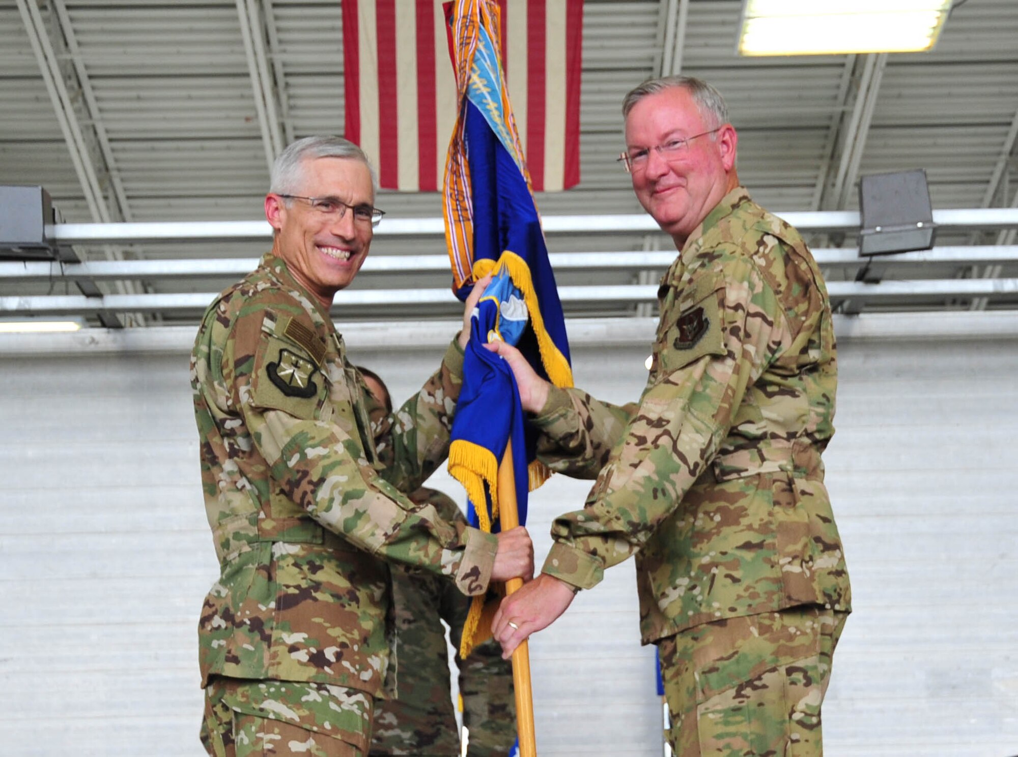 Maj. Gen. Craig L. LaFave, 22nd Air Force commander, passes the 403rd guidon to Col. Jeffrey A. Van Dootingh, during the 403rd Wing change of command ceremony June 9, 2019 at Keesler Air Force Base, Mississippi. (U.S. Air Force photo by Tech. Sgt. Michael Farrar)