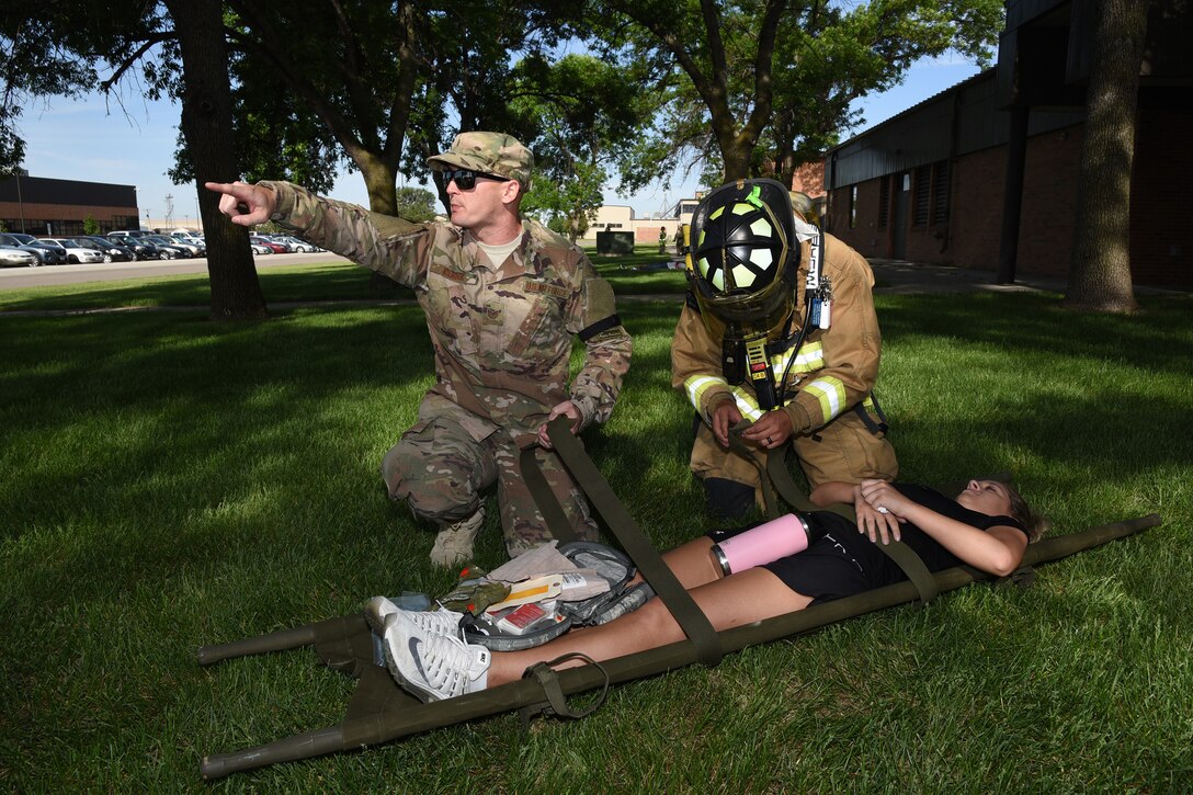 Tech. Sgt. Matthew Clark, a fire fighter in the 119th Civil Engineer Squadron, shouts instructions, as he leads a group responding to an emergency call after a simulated enemy attack during a training exercise at the North Dakota Air National Guard Base, Fargo, N.D., June 7, 2019.