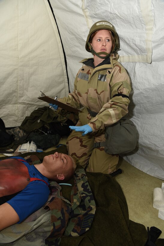 Staff Sgt. Kally Anderson, of the 119th Medical Group, administers medical treatment to an Airman who is acting as an attack victim during a training exercise at the North Dakota Air National Guard Base, Fargo, N.D., June 8, 2019.