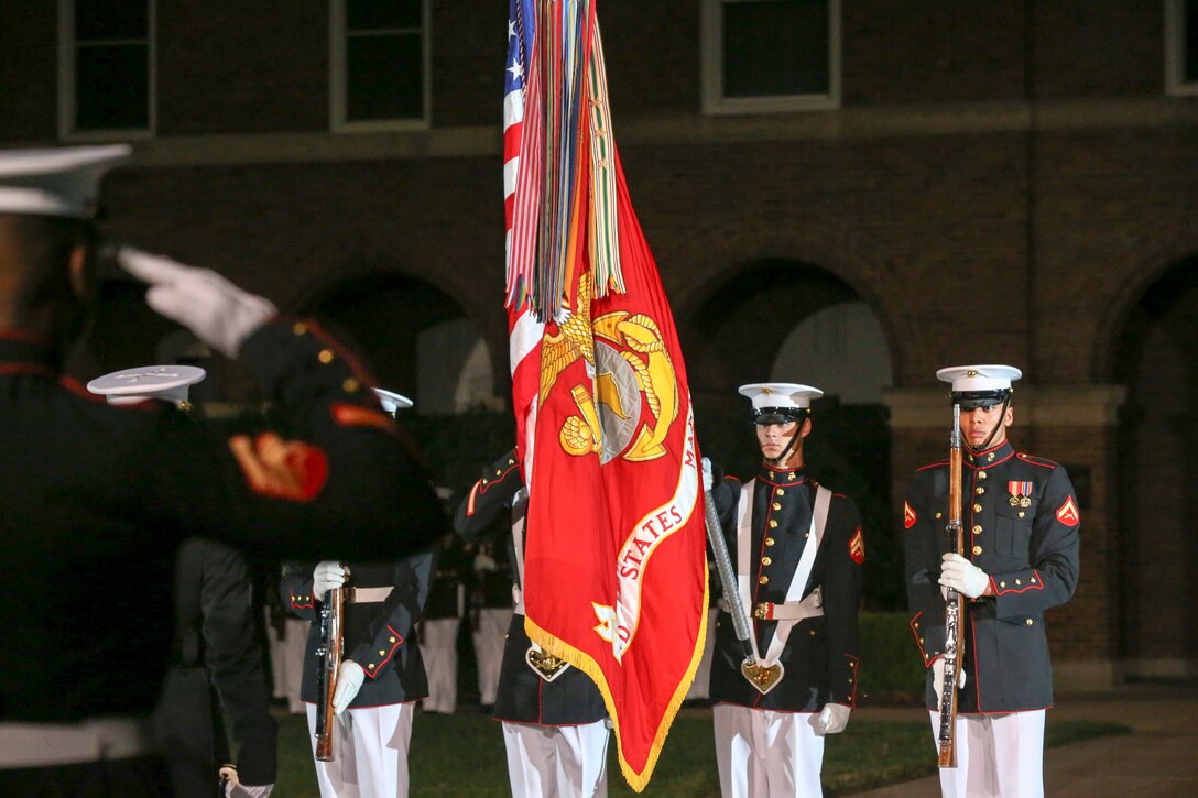 Marine with the U.S. Marine Corps Color Guard present the National Flag during a Friday Evening Parade at Marine Barracks Washington, D.C., June 07, 2019. The hosting official for the evening was Lt. Gen. Michael Dana, the director of Marine Corps Staff, and the guest of honor was Ms. Cora Storbeck, the president of the Hallmark Corporate Foundation and director of Community Involvement at Hallmark. (U.S. Marine Corps photo by Pfc. Allen Sanders)