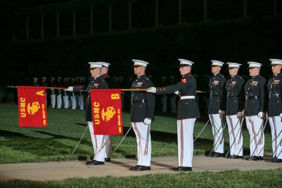 Alpha and Bravo Company guidon bearers present the company guidons during a Friday Evening Parade at Marine Barracks Washington, D.C., June 07, 2019. The hosting official for the evening was Lt. Gen. Michael Dana, the director of Marine Corps Staff, and the guest of honor was Ms. Cora Storbeck, the president of the Hallmark Corporate Foundation and director of Community Involvement at Hallmark. (U.S. Marine Corps photo by Pfc. Allen Sanders)