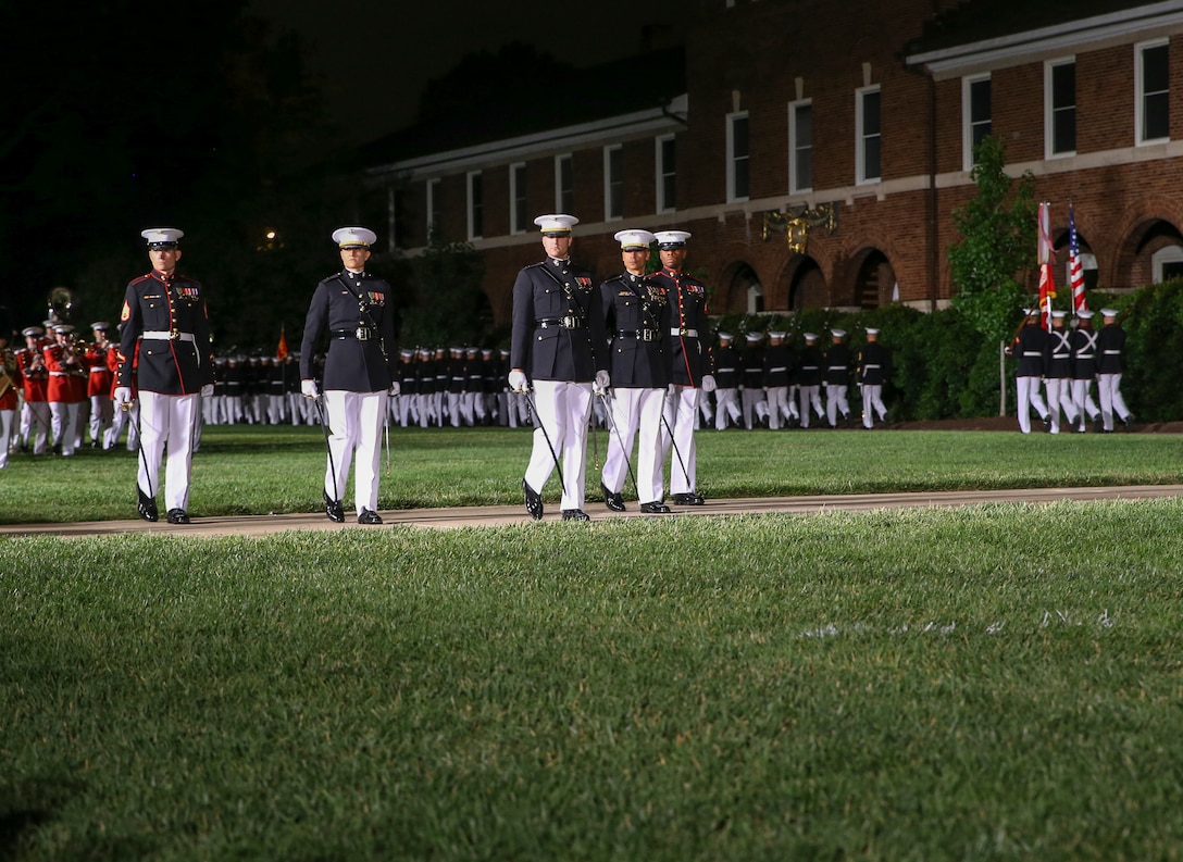Marines with Marine Barracks Washington D.C. parade marching staff perform “eyes right” during a Friday Evening Parade at the Barracks, June 07, 2019. The hosting official for the evening was Lt. Gen. Michael Dana, the director of Marine Corps Staff, and the guest of honor was Ms. Cora Storbeck, the president of the Hallmark Corporate Foundation and director of Community Involvement at Hallmark. (U.S. Marine Corps photo by Pfc. Allen Sanders)