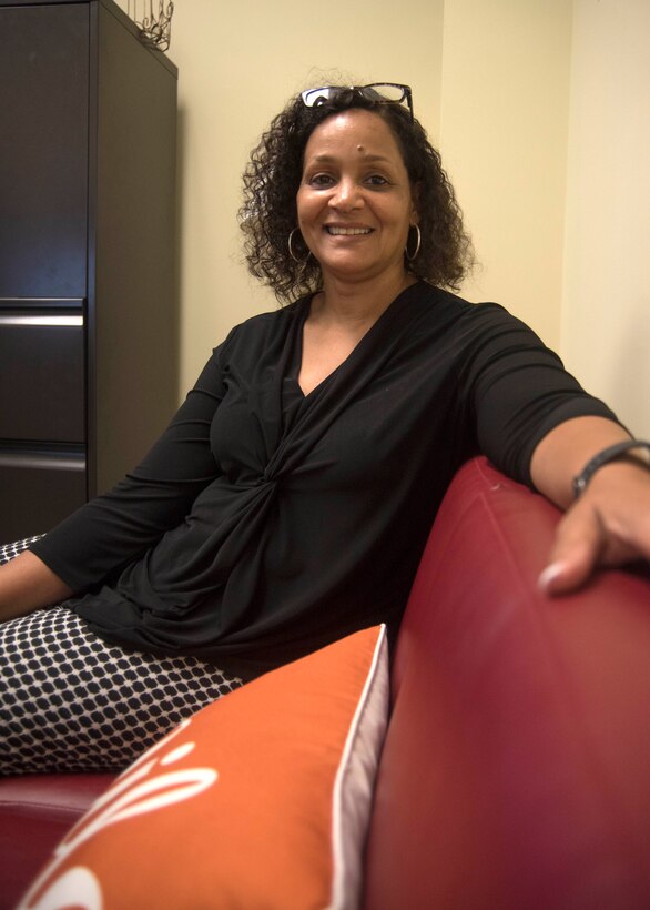 Brenda Edmond, 315th Airlift Wing Director of Psychological Health at Joint Base Charleston, invites guests to have a seat on her red couch, June 5, 2019, at her JB Charleston office in the Reserve Medical building. Edmond assumed the position of Director of Psychological Health in April 2019, after nearly 30 years of social work and mental health experience. (U.S. Air Force photo/Staff Sgt. Della S. Creech)