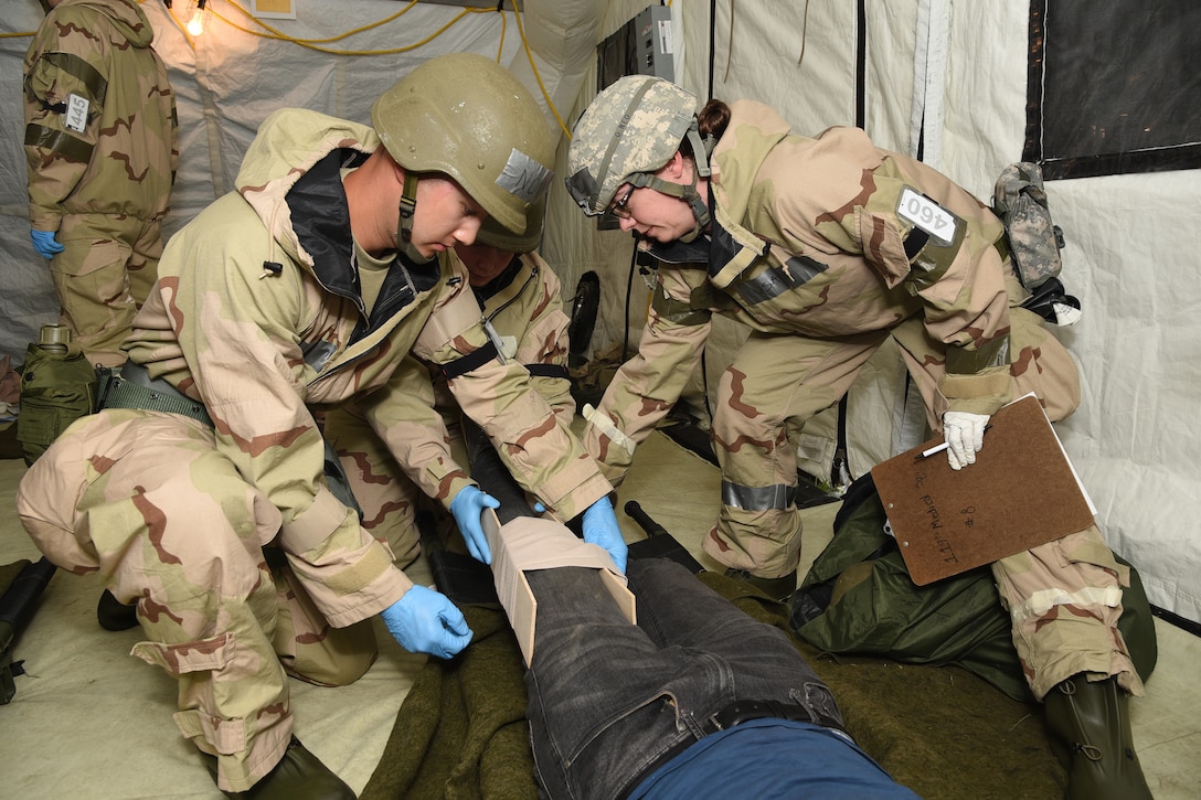 Senior Airman Christopher Novotny, left, and 1st Lt. Rebecca Stutz, both of the 119th Medical Group, splint a simulated injury during a training exercise at the North Dakota Air National Guard Base, Fargo, N.D., June 8, 2019.