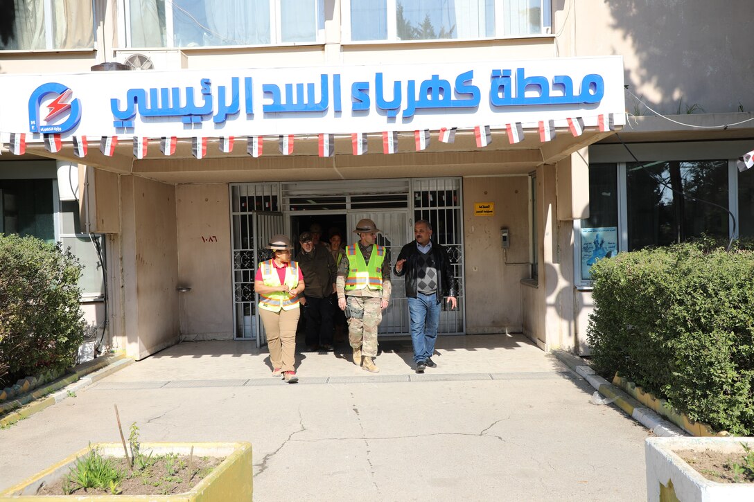 Members of the Mosul Dam Task Force exit a Ministry of Water Resources building at the Mosul Dam.