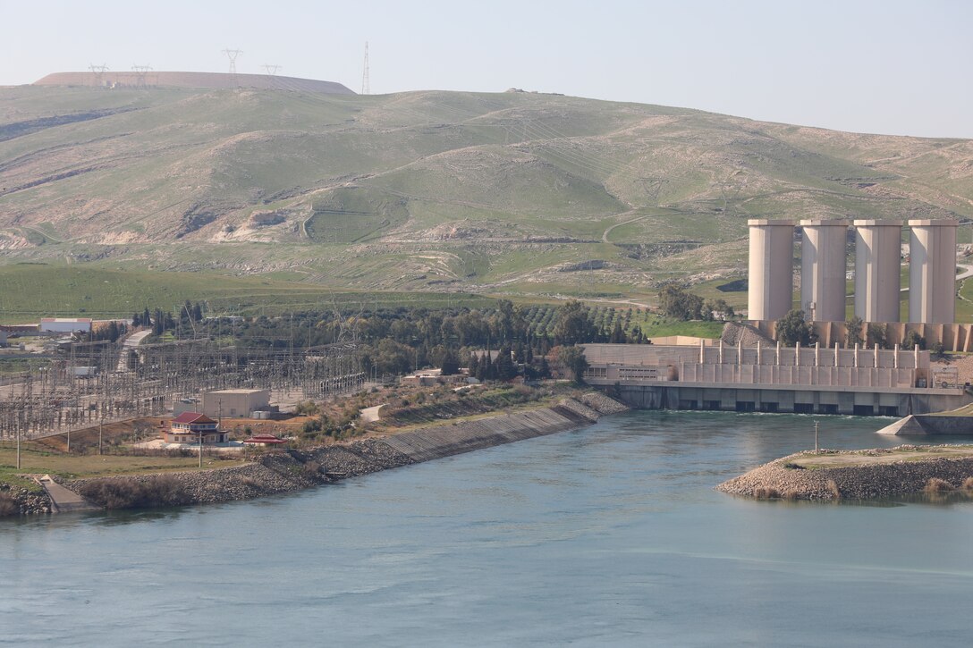The Mosul Dam, with its the hydropower plant and four water storage towers, sits in a valley along the Tigris River approximately 30 miles outside Mosul City in Iraq. The dam is the largest in Iraq, and the fourth largest in the Middle East. It supplies water, hydropower, irrigation and flood control to the region.