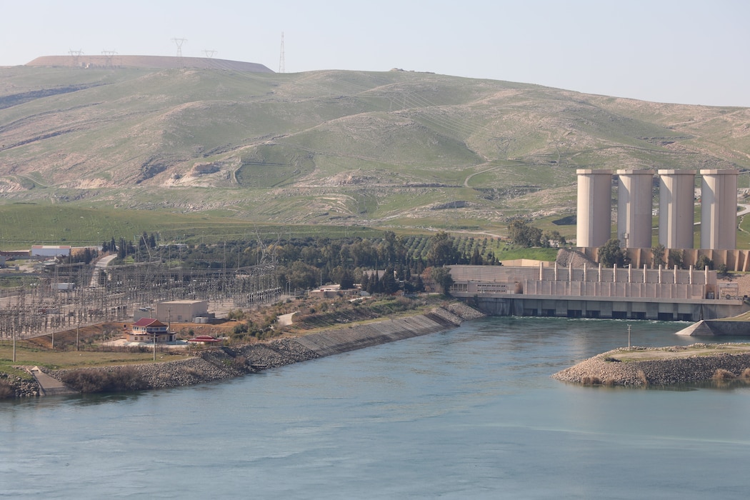 Mosul Dam, with its the hydropower plant and four water storage towers, sits in a valley along the Tigris River 30 miles outside Mosul City in Iraq.. It is the largest dam in Iraq, and the fourth largest in the Middle East and supplies water, hydropower, irrigation and flood control to the region.