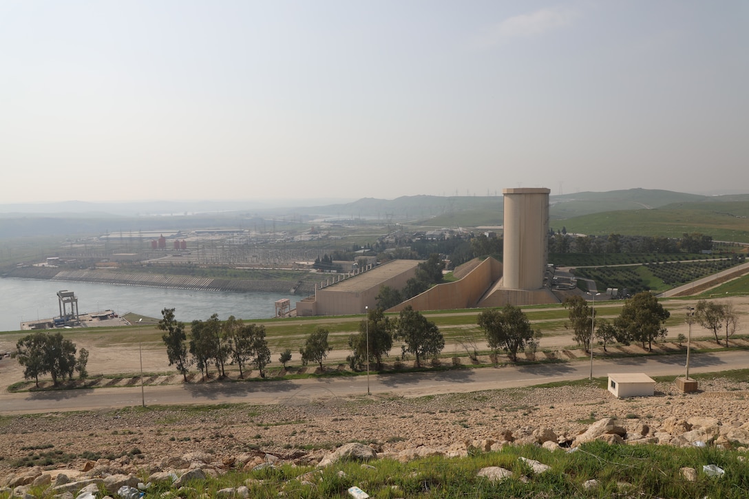 The Mosul Dam, with its the hydropower plant and four water storage towers, sits in a valley along the Tigris River approximately 30 miles outside Mosul City in Iraq. The dam is the largest in Iraq, and the fourth largest in the Middle East. It supplies water, hydropower, irrigation and flood control to the region.