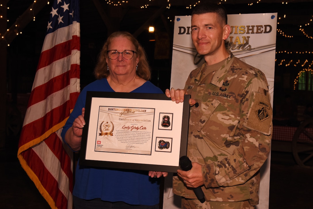 Lt. Col. Cullen Jones (Right), U.S. Army Corps of Engineers Nashville District commander, presents the Distinguished Civilian Employee Recognition Award to Emily Care during the Engineer Day Picnic June 7, 2019 in Ridgetop, Tenn. Carr served in the Nashville District from 1983 to 2016. The award recognizes exceptional retirees who have served honorably and contributed substantially to the reputation of the Corps of Engineers. (USACE photo by Lee Roberts)