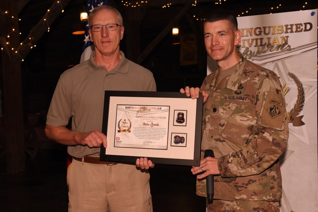 Lt. Col. Cullen Jones (Right), U.S. Army Corps of Engineers Nashville District commander, presents the Distinguished Civilian Employee Recognition Award to Michael Zoccola during the Engineer Day Picnic June 7, 2019 in Ridgetop, Tenn. Zoccola served in the Nashville District from 1976 to 2016. The award recognizes exceptional retirees who have served honorably and contributed substantially to the reputation of the Corps of Engineers. (USACE photo by Lee Roberts)