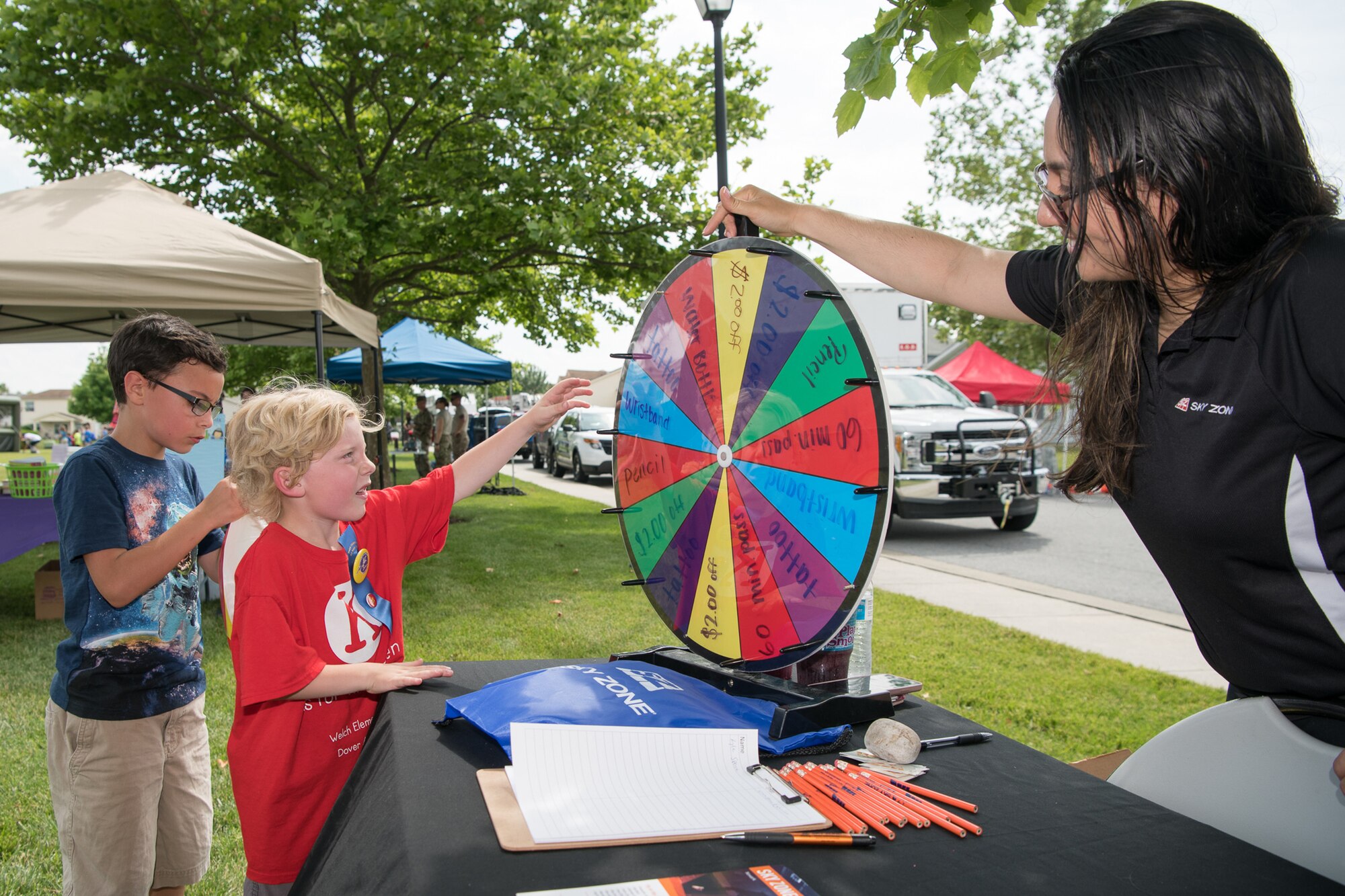 Children spin a wheel for a chance to win prizes from Sky Zone trampoline park located in  Newark during the Hurricane Block Party June 6, 2019, at the Eagle Heights family housing on Dover Air Force Base, Del. This year’s block party offered attendees the chance to meet with four military agencies and 13 local vendors. (U.S. Air Force Photo by Mauricio Campino)