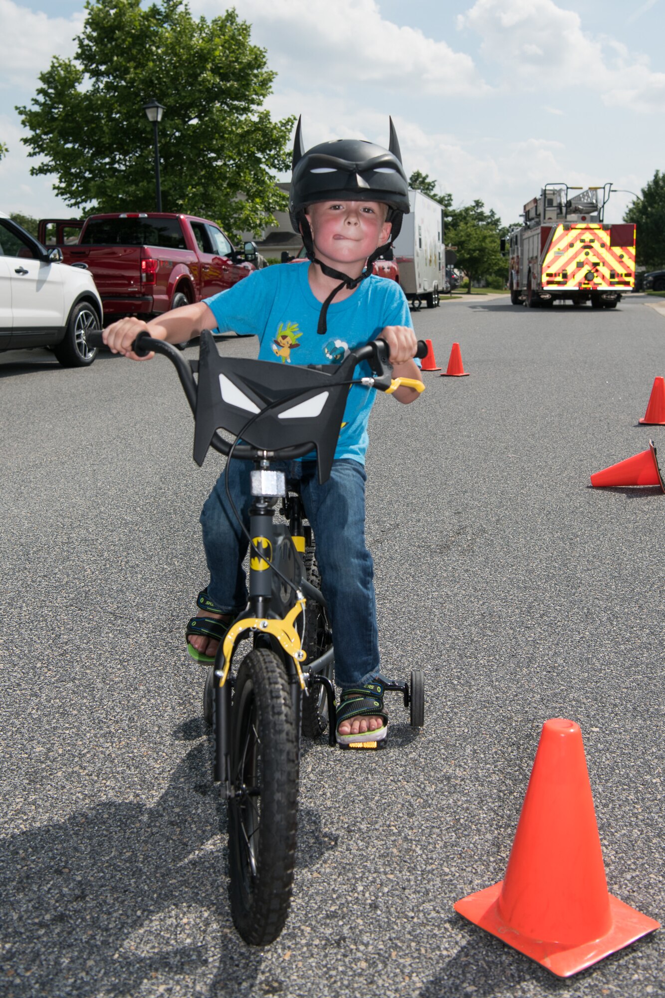Nicholas Roof Jr. rides his bicycle through a safety course at the Hurricane Block Party June 6, 2019, at the Eagle Heights family housing on Dover Air Force Base, Del.  The course was set up by the 436th Security Forces squadron to show children how to maneuver around obstacles, test their brakes and to inspect the fit of their helmets. (U.S. Air Force Photo by Mauricio Campino)