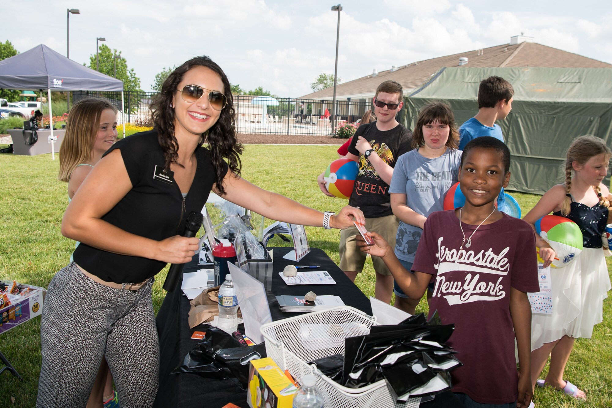 Jessica Ekin, director of marketing and business development for the Dover Mall and Dover commons, hands out raffle prizes to attendees of the Hurricane Block Party June 6, 2019, at the Eagle Heights family housing on Dover Air Force Base, Del. In addition to free food donated and prepared by the Eagle Heights housing staff,  door prizes and raffles were also donated by the various vendors in attendance. (U.S. Air Force Photo by Mauricio Campino)