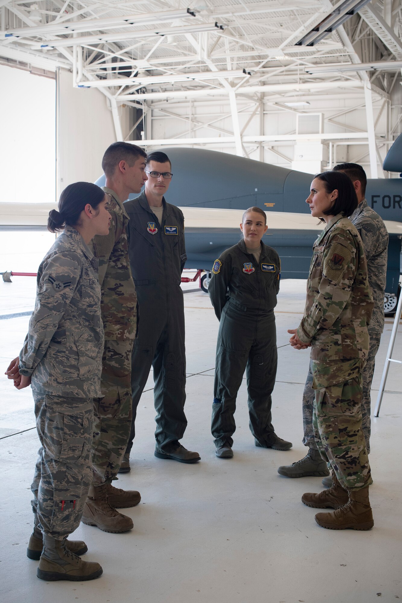 Chief Master Sgt. Summer Leifer, 25th Air Force command chief, right, talks to members of the 69th Reconnaissance Group and 69th Maintenance Squadron following a brief they delivered to her June 5, 2019, on Grand Forks Air Force Base, North Dakota. The brief provided to Leifer was about the operations and capabilities of the RQ-4 Global Hawk, which is Grand Forks AFB’s primary mission. (U.S Air Force photo by Senior Airman Elora J. Martinez)