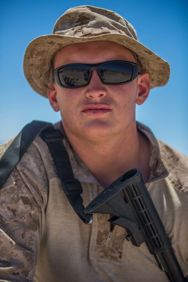 U.S. Marine Lance Cpl. Cameron Coburn, an assault amphibious vehicle crewman with 4th Assault Amphibious Battalion, 4th Marine Division, poses for a photo at Observation Post Left during Integrated Training Exercise 4-19 at Marine Corps Air Ground Combat Center, Twentynine Palms, Calif., June 8, 2019. Today’s Marine Reserve is a critical component of the Marine Corps’ Total Force, and training like ITX helps ensure Reserve units combat effectiveness and proficiency for world-wide deployment. (U.S. Marine Corps photo by Lance Cpl. Preston L. Morris)
