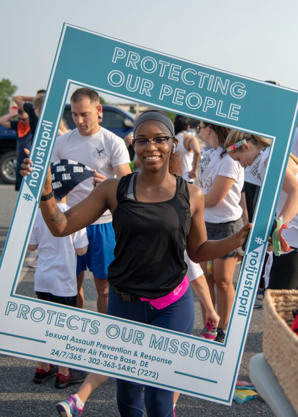 A run participant, poses for a photo at the 2019 Sexual Assault Prevention and Response Color Run June 5, 2019, at Dover Air Force Base, Del. The purpose of the run was to raise awareness of sexual assault and to reinforce the motto, “protecting our people protects our mission.” (U.S. Air Force photo by Staff Sgt. Esteban Esquivel)