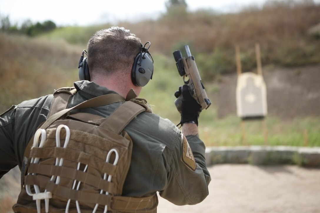 Sgt. Davin Crews, a Marine with Marine Corps Air Station Miramar Special Reactions Team (SRT), pauses to reload the M1911 Service Pistol during training at MCAS Miramar, Calif., June 5. This training is regularly conducted to sharpen the Marines’ skills and further the Marine Corps’ mission of operational readiness. (U.S. Marine Corps photo by Lance Cpl. Cheng Chang)