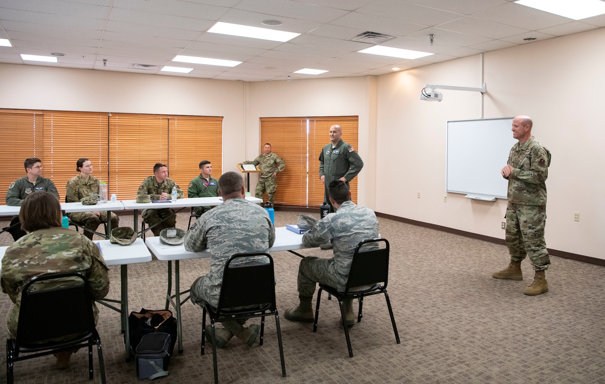 Commander and command chief congratulate Additional Duty First Sergeants.