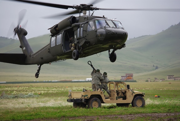 Soldiers with the 19th Special Forces and 2nd Battalion 211th Aviation Regiment conduct sling load operations during annual training at Camp Williams.