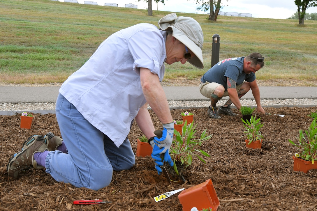(left to right) Bee Hall and Steve Vlaming, both 75th Civil Engineering Group, plant vegetation at the new pollinator garden plot, June 6, 2019, at Hill Air Force Base, Utah. The garden will provide food and habitat for pollinator species such as hummingbirds, bees, and other insects, which are critical to maintaining diverse and healthy ecosystems. (U.S. Air Force photo by Todd Cromar)