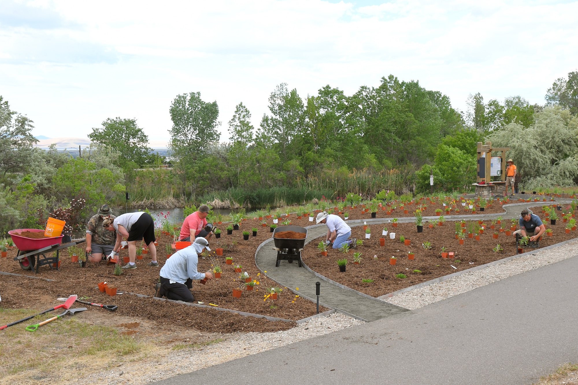 Natural Resource staff and volunteers work together planting a new pollinator garden plot, June 6, 2019, at Hill Air Force Base, Utah. The garden will provide food and habitat for pollinator species such as hummingbirds, bees, and other insects, which are critical to maintaining diverse and healthy ecosystems. (U.S. Air Force photo by Todd Cromar)