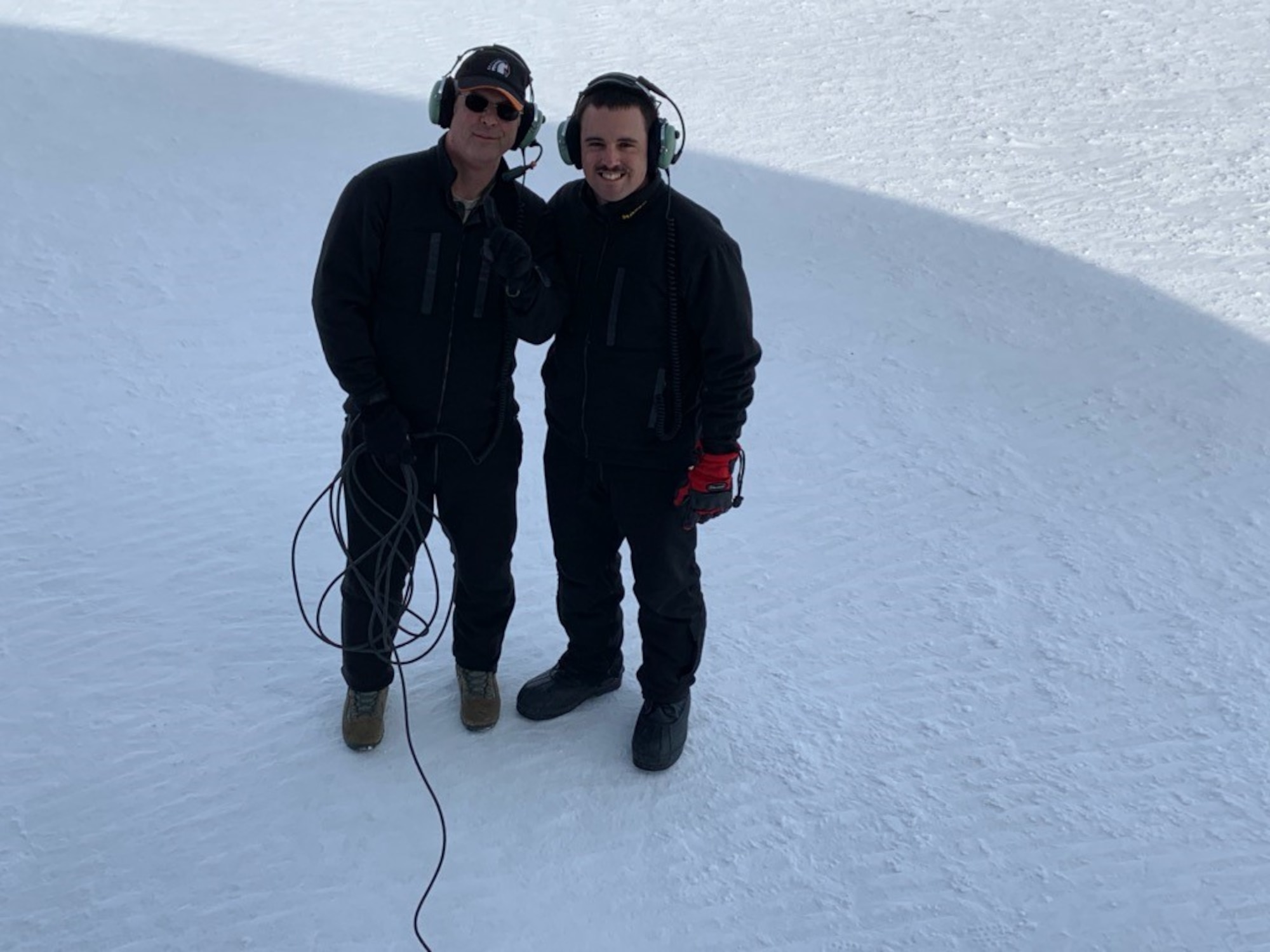 Chief Master Sgt. James Masura Jr., 313th Airlift Squadron loadmaster, and Senior Airman Chandler Smith, 313th AS loadmaster, pause for a photo while on an Operation Deep Freeze mission to the Antarctic. This mission was Masura’s 100th, a record for C-17 Globemaster III supporting the U.S Antarctic Program’s National Science Foundation research operations. (Courtesy photo)