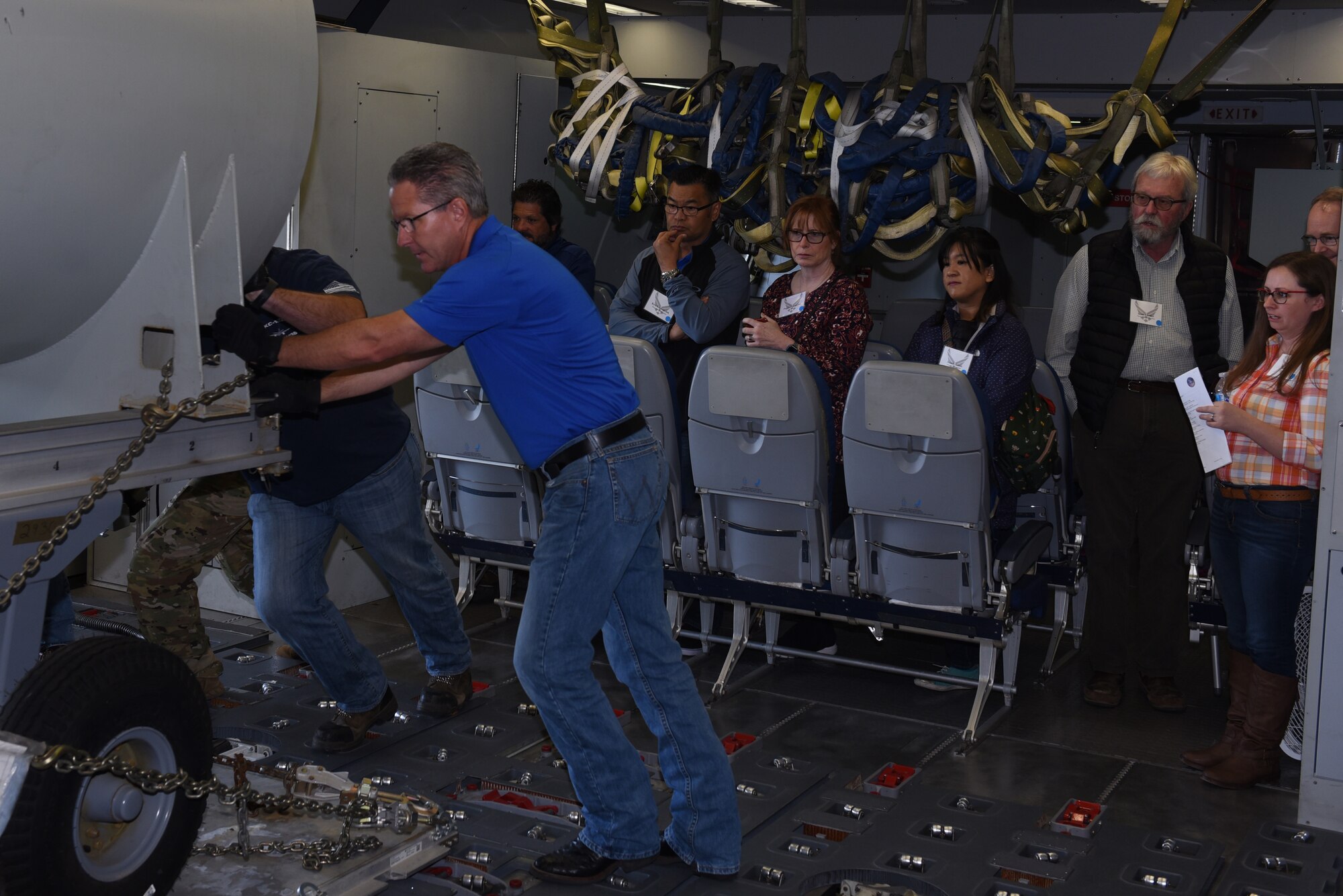 Honorary Commanders watch as Flight Safety Services Corporation members simulate loading cargo on a KC-10 Extender June 7, 2019, at Travis Air Force Base, California. The purpose of the Travis’ Honorary Commander Program is to promote relationships between base senior leadership and civilian partners, foster civic appreciation of the Air Force mission and its Airmen, maximize opportunities to share the Air Force story with new stewards and to communicate mutual interest, challenges and concerns that senior leaders and civilian stakeholders have in common. (U.S. Air Force photo by Airman 1st Class Cameron Otte)