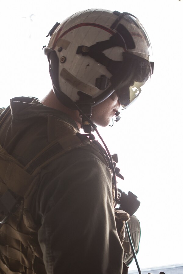 U.S. Marine Cpl. James Snow, a crew chief with Marine Medium Tiltrotor Squadron (VMM) 161, Marine Aircraft Group (MAG) 16, 3rd Marine Aircraft Wing (MAW), observes his surroundings during MAG-16’s mass flight exercise at Marine Corps Air Station (MCAS) Miramar, Calif., June 6, 2019.  3rd MAW Marines’ invaluable contributions to the operational excellence of equipment and aircraft made MAG-16’s mass launch ensure the units remain trained and ready to serve as an integral component of the Marine Air-Ground Task Force (MAGTF) by providing the aviation combat element for I Marine Expeditionary Force – the Marine Corps’ largest MAGTF. (U.S. Marine Corps photo by Pfc. Ian M. Simmons)