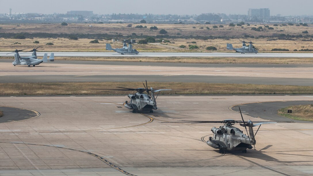 U.S. Marine Corps MV-22B Ospreys with Marine Medium Tiltrotor Squadrons (VMM) 161, 165 and 166, along with CH-53E Super Stallions with Marine Heavy Helicopter Squadrons (HMH) 361, 465 and 466, Marine Aircraft Group (MAG) 16, 3rd Marine Aircraft Wing (MAW), stage on the flight line during MAG-16’s mass flight exercise at Marine Corps Air Station Miramar, Calif., June 6, 2019. The training exercise set the standard for operational excellence with an epic coordinated flight, which featured more than 40 aircraft. (U.S. Marine Corps photo by Pfc. Emely Gonzalez)