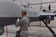 Staff Sgt. Justin, 432nd Aircraft Maintenance Squadron, unveils the name of the incoming 432nd Wing/432nd Air Expeditionary Wing commander on an MQ-9 Reaper during the 432nd WG change of command ceremony at Creech Air Force Base, Nevada, June 7, 2019. During the event, Col. Stephen Jones assumed command of the award-winning Remotely Piloted Aircraft wing from Col. Julian Cheater. (U.S. Air Force photo by Airman 1st Class Haley Stevens)