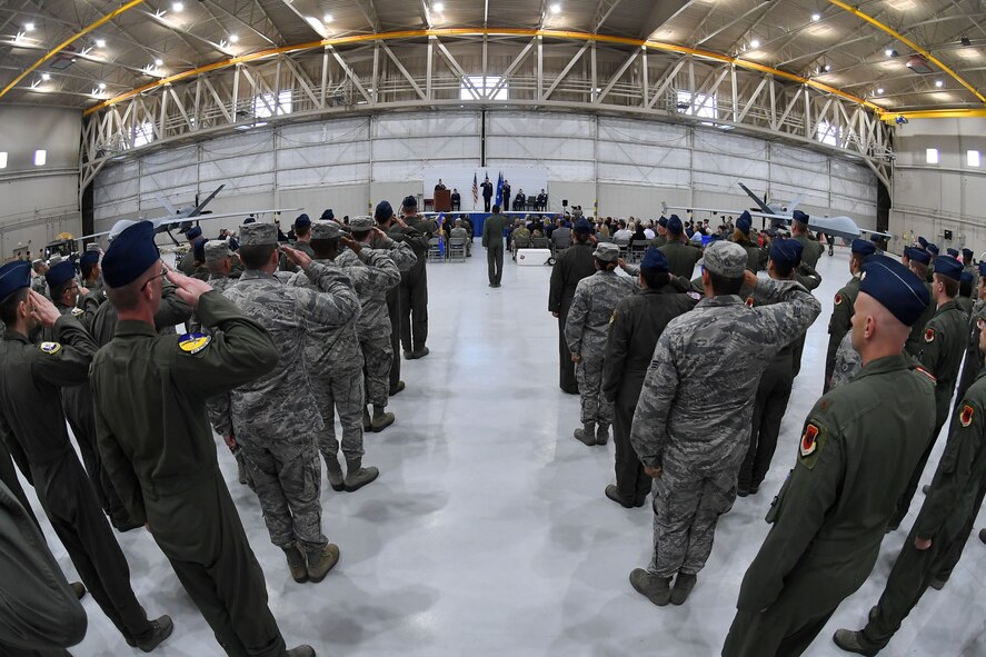 Col. Julian Cheater, outgoing 432nd Wing/432nd Air Expeditionary Wing commander, receives his final salute from Creech Airmen during the 432nd WG/432nd AEW change of command ceremony at Creech Air Force Base, Nevada, June 7, 2019. Cheater’s advocacy resulted in the first-ever achievement decoration awarded to Remotely Piloted Aircraft aircrew for having direct and immediate impact on the battlefield, and he spearheaded efforts for a better quality of life for Creech Airmen, earning Cheater the Legion of Merit. (U.S. Air Force photo by Staff Sgt. James Thompson)
