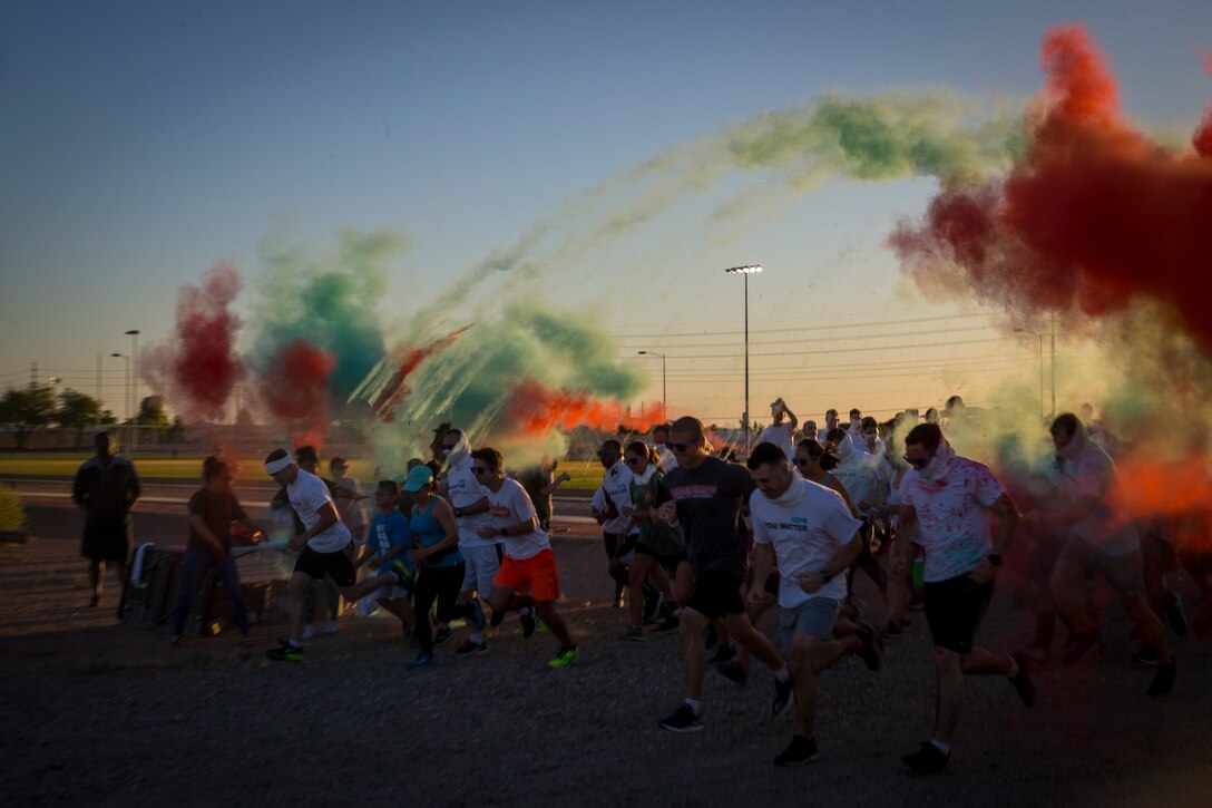 U.S. Marines stationed at Marine Corps Air Station (MCAS) Yuma take part in the Sexual Assault Prevention and Response color run on MCAS Yuma, Ariz., April 25, 2019. The 5 kilometer run took place in April, in order to support Sexual Assault Awareness Month. (U.S. Marine Corps photo by Pfc. John Hall)