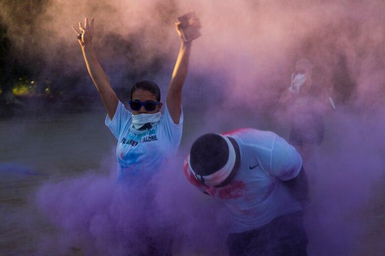 U.S. Marines stationed at Marine Corps Air Station (MCAS) Yuma take part in the Sexual Assault Prevention and Response color run on MCAS Yuma, Ariz., April 25, 2019. The 5 kilometer run took place in April, in order to support Sexual Assault Awareness Month. (U.S. Marine Corps photo by Pfc. John Hall)