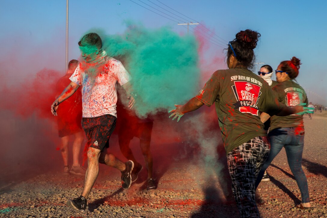 U.S. Marines stationed at Marine Corps Air Station (MCAS) Yuma take part in the Sexual Assault Prevention and Response color run on MCAS Yuma, Ariz., April 25, 2019. The 5 kilometer run took place in April, in order to support Sexual Assault Awareness Month. (U.S. Marine Corps photo by Pfc. John Hall)