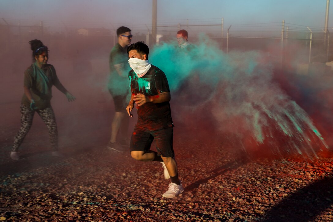 U.S. Marines stationed at Marine Corps Air Station (MCAS) Yuma take part in the Sexual Assault Prevention and Response color run on MCAS Yuma, Ariz., April 25, 2019. The 5 kilometer run took place in April, in order to support Sexual Assault Awareness Month. (U.S. Marine Corps photo by Pfc. John Hall)
