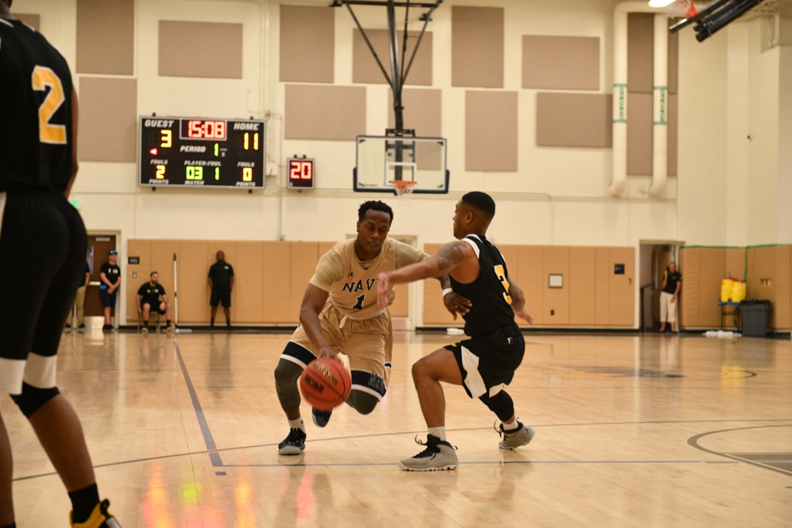 Navy Lt. J.G. Tilman Dunbar stationed aboard the USS Bataan drives past Army Spc. Alex Bradley of Kaiserslautern, Germany during Navy's gold medal victory. Elite U.S. military basketball players from around the world compete for dominance at Naval Station Mayport during the 2019 Armed Forces Men's and Women's Basketball Championship. Army, Marine Corps, Navy (with Coast Guard) and Air Force teams square off at the annual event which features double round-robin action, followed by championship and consolation games to crown the best players in the military. (U.S. Navy photo by Mass Communication Specialist 1st Class Gulianna Dunn/RELEASED)
