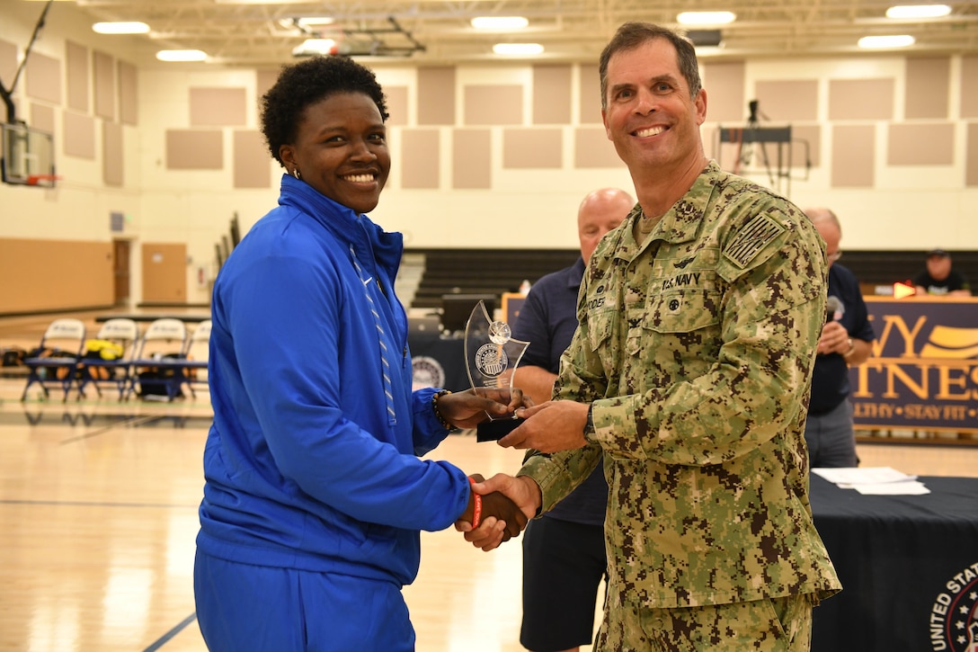 Air Force 2nd lt. Charmaine Clark of Robbins AFB, Ga. is presented All-Tournament Team honors by Navy Capt. David Yoder, Commander of Naval Station Mayport, Fla. Elite U.S. military basketball players from around the world compete for dominance at Naval Station Mayport during the 2019 Armed Forces Men's and Women's Basketball Championship. Army, Marine Corps, Navy (with Coast Guard) and Air Force teams square off at the annual event which features double round-robin action, followed by championship and consolation games to crown the best players in the military. (U.S. Navy photo by Mass Communication Specialist 1st Class Gulianna Dunn/RELEASED)