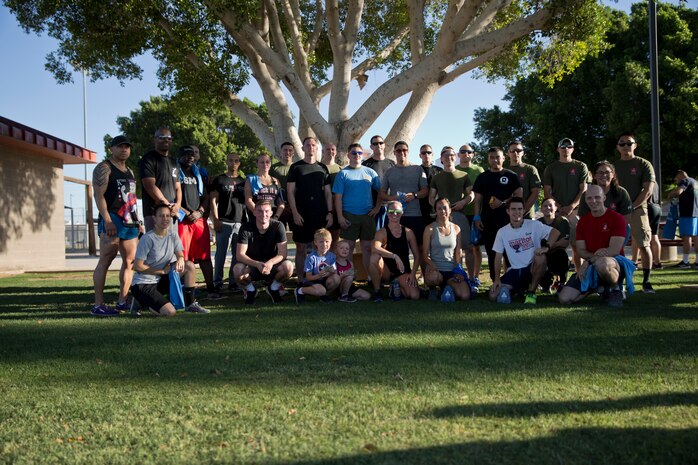 U.S. Marines Stationed at Marine Corps Air Station (MCAS) Yuma and their families pose for a photo after participating in the 2019 Environmental Earth Day Fun Run at MCAS Yuma Ariz., April 26, 2019. The Environmental Earth Day Fun Run is a 5k race held annually bringing awareness to Marines, Sailors, and civilians about the protection of our environment. (U.S. Marine Corps photo by Lance Cpl. Joel Soriano)